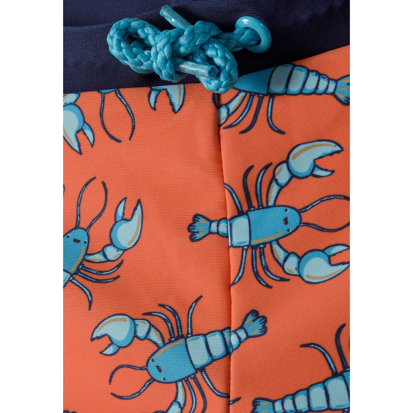 Close-up detail of blue rope drawstring and lobster print pattern on orange swim shorts fabric