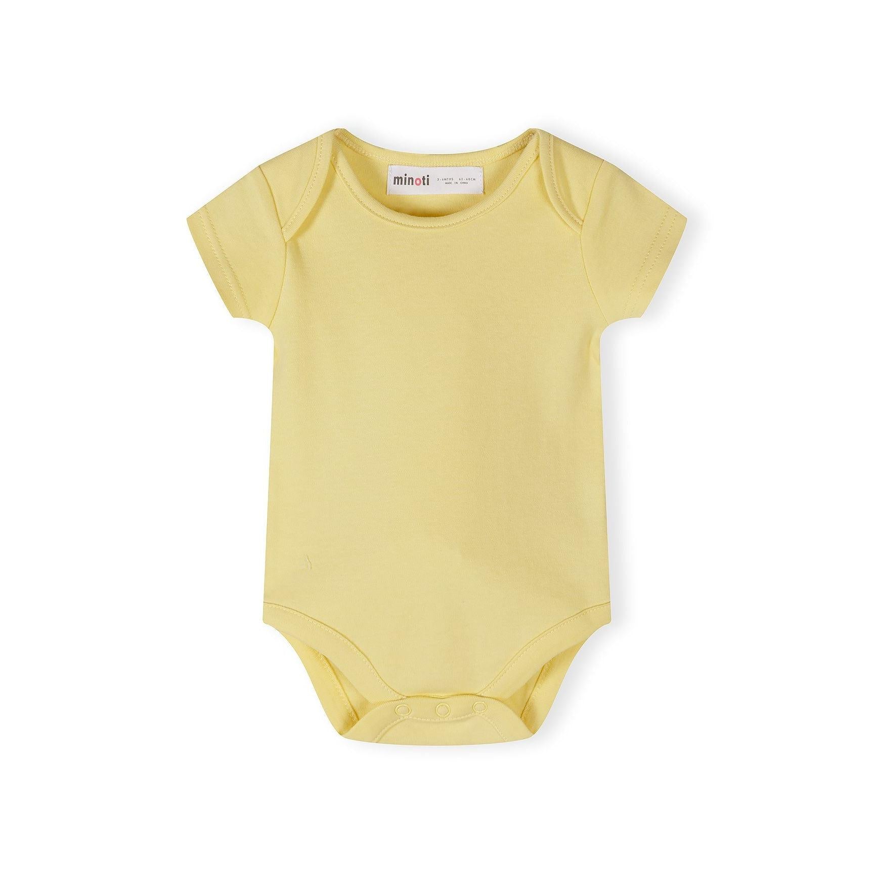 Close-up detail of cream bodysuit showing Minoti label and colorful polka dot pattern in yellow, mint, grey and coral