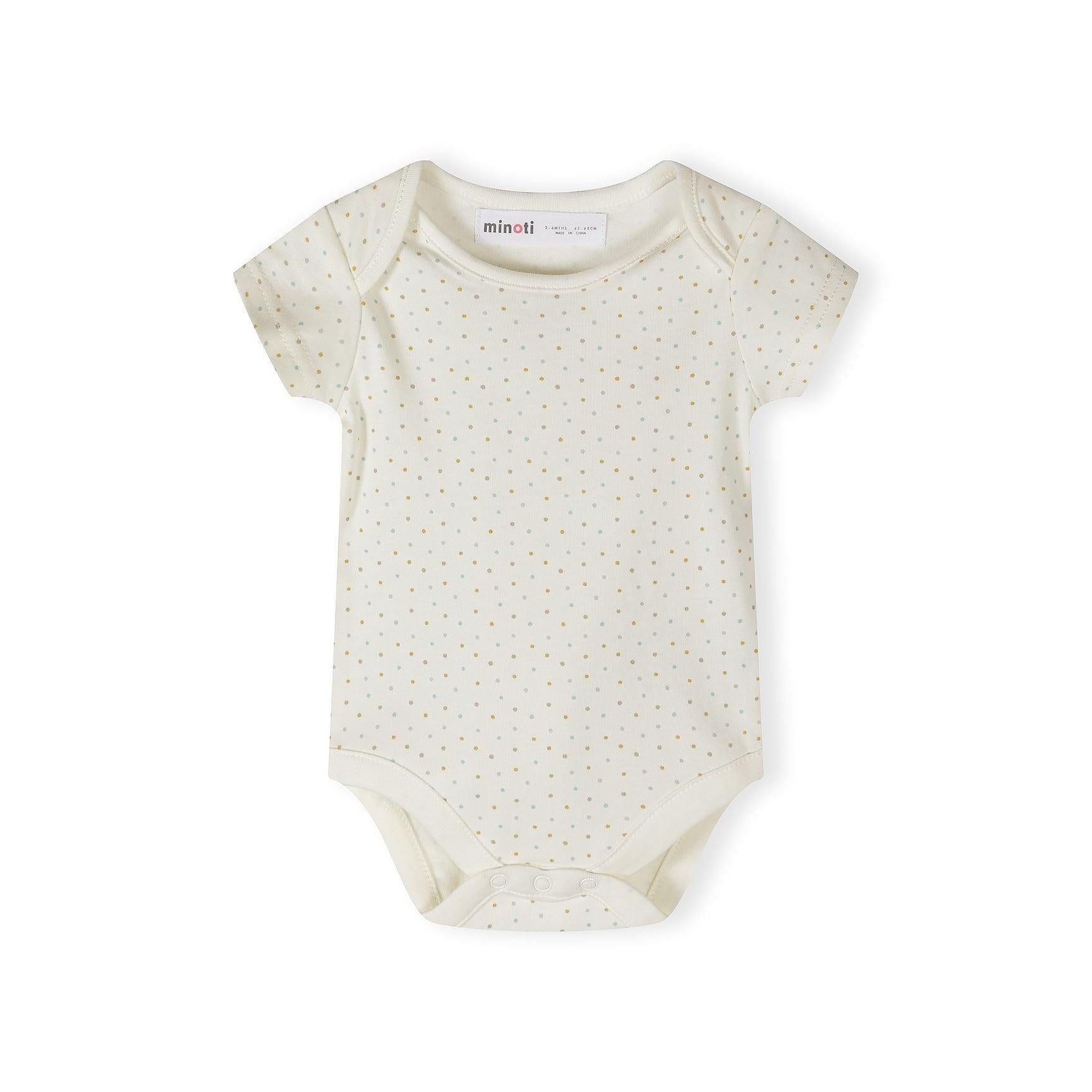 Close-up detail of cream bodysuit showing Minoti label and colorful polka dot pattern in yellow, mint, grey and coral