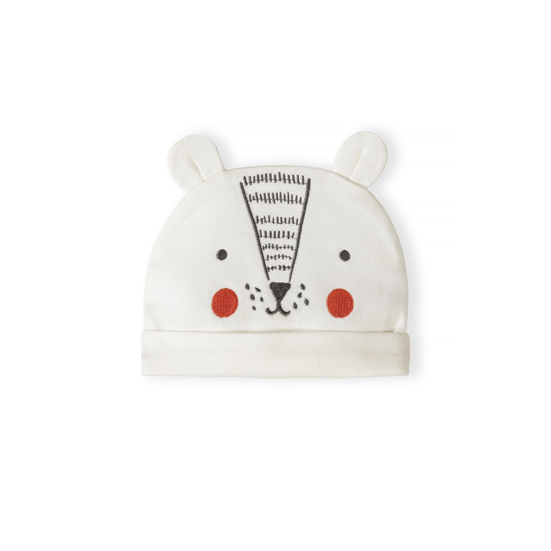 Close-up of cream cotton baby hat with embroidered bear face design featuring black eyes, orange cheeks and striped nose detail with small ears