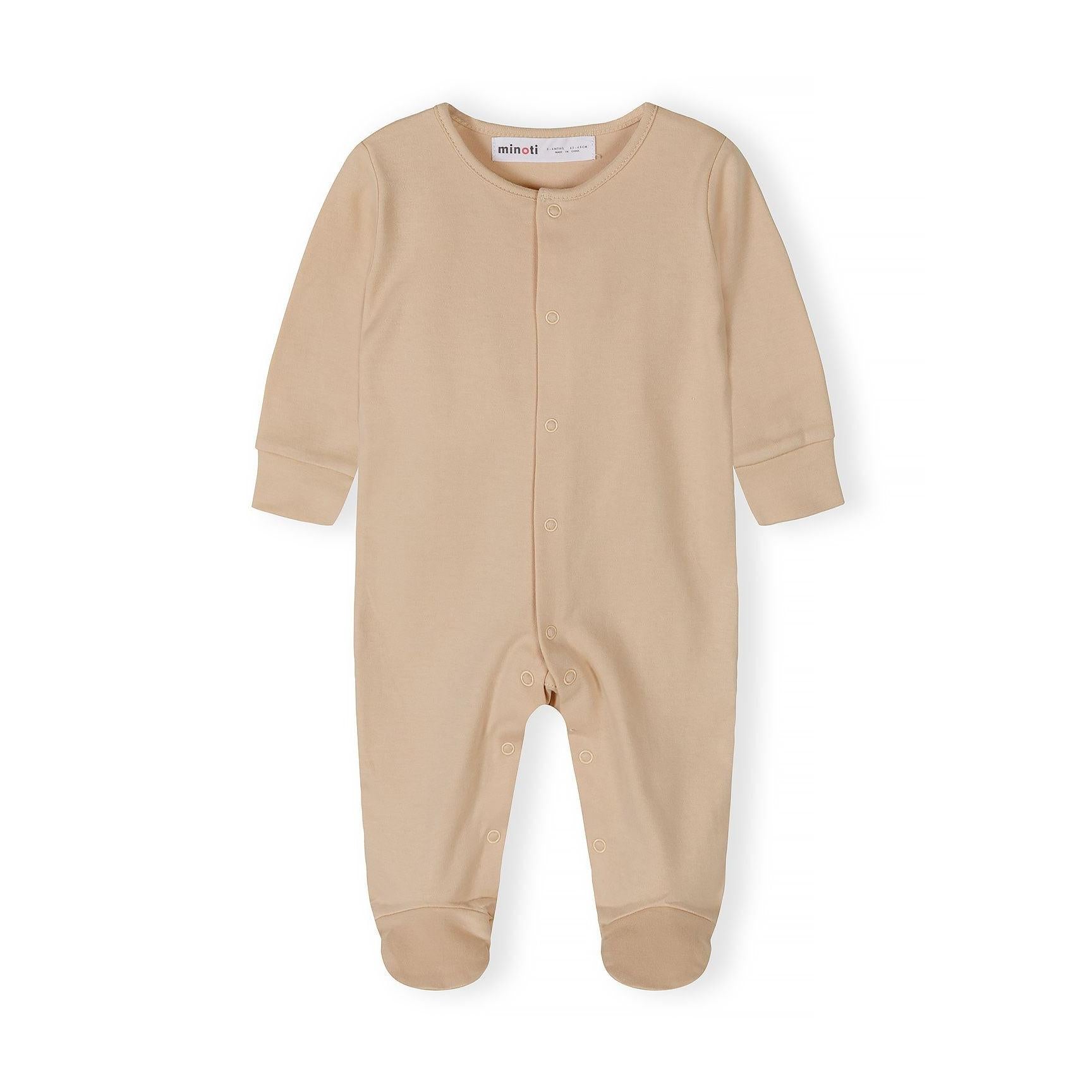 Close-up detail of cream sleepsuit showing Minoti label, snap button closure and soft cotton texture with ribbed neckline
