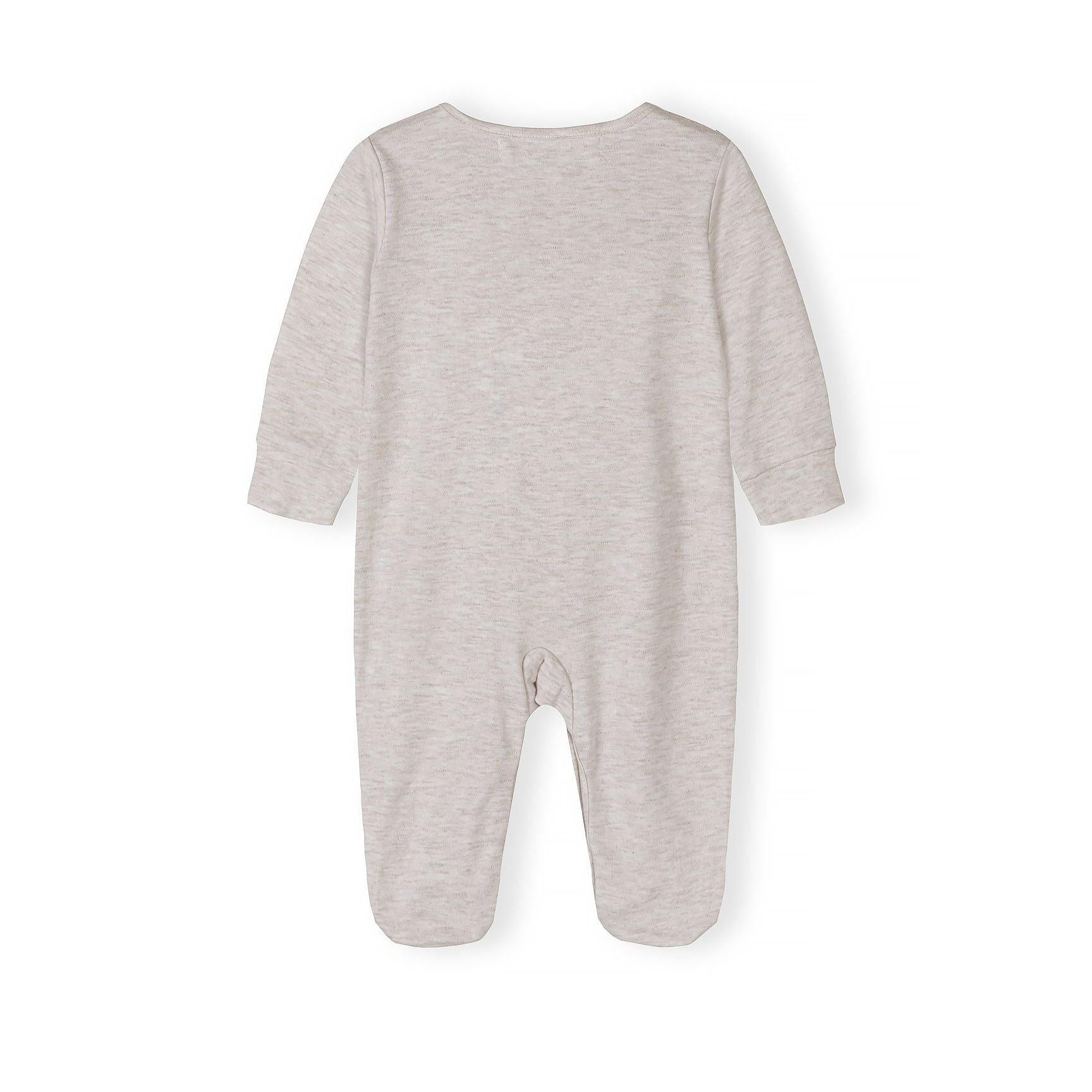 Close-up detail of cream sleepsuit showing Minoti label, snap button closure and soft cotton texture with ribbed neckline