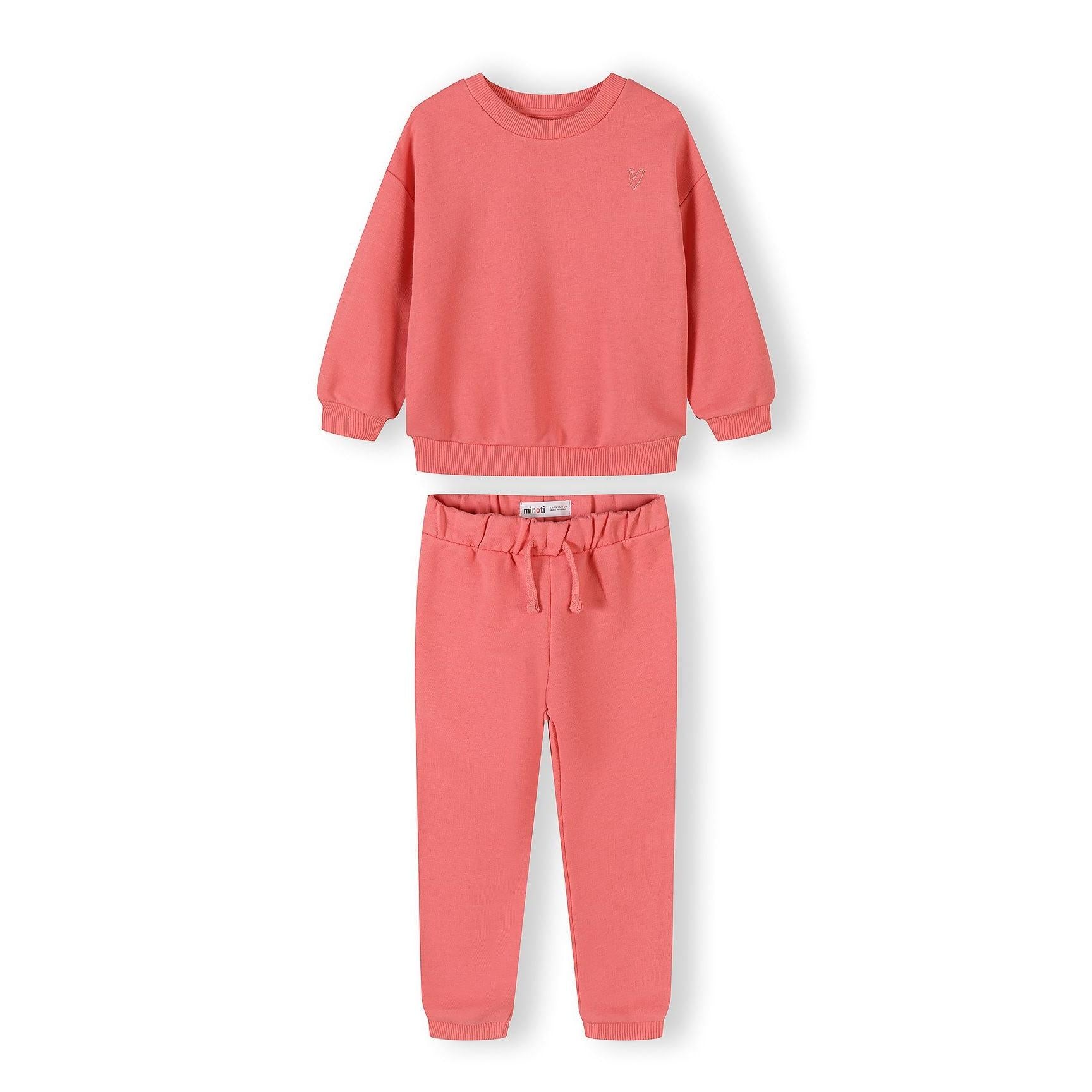 Cream tracksuit set with sweatshirt and joggers laid flat showing ribbed details and elastic waistband on white background