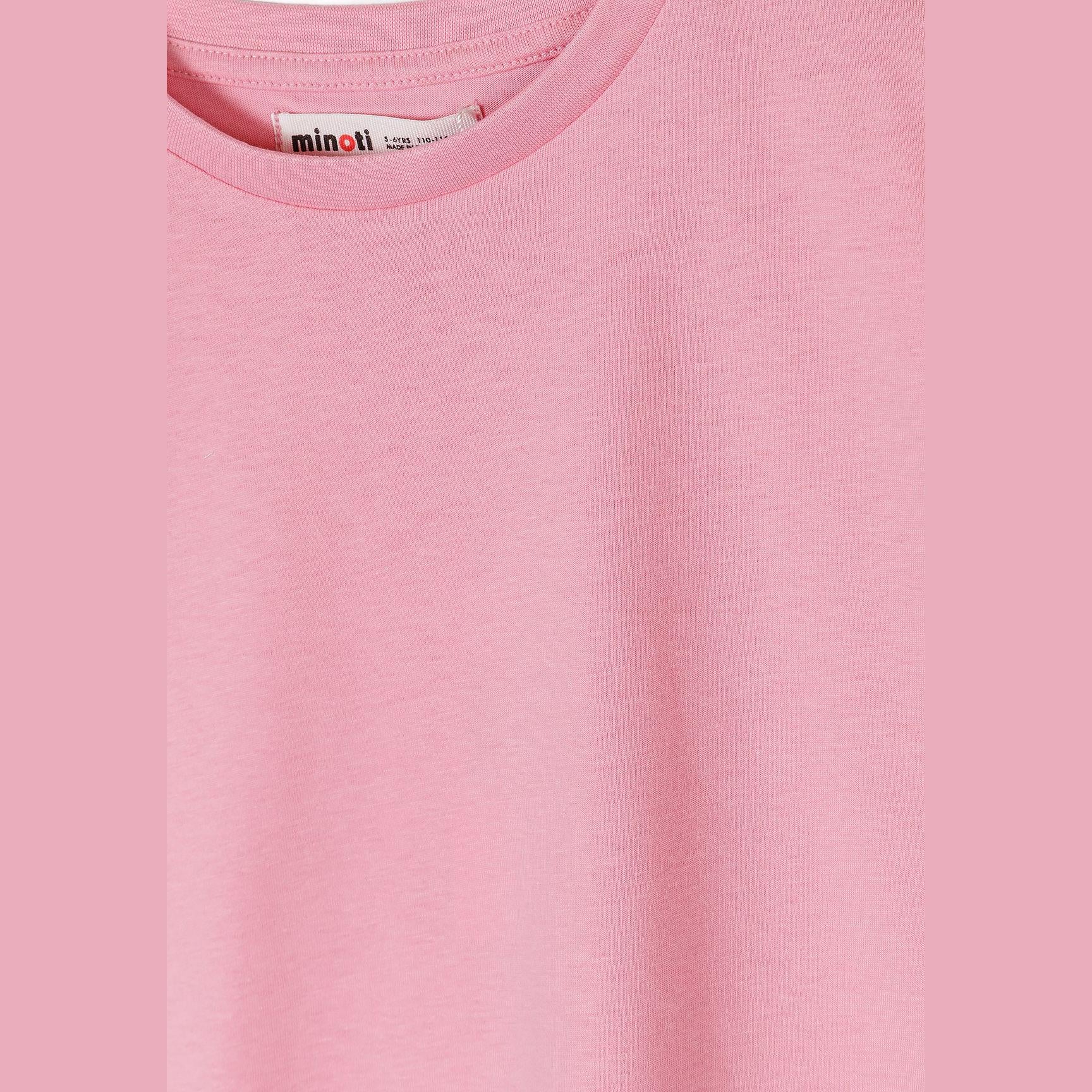 Close-up detail of pink t-shirt showing Minoti brand label at neck and soft jersey fabric texture