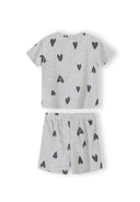 Close-up detail of cream ribbed fabric texture showing hand-drawn black hearts print pattern and crew neckline