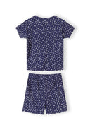 Close-up detail of white ribbed fabric with navy floral print pattern showing Minoti brand label