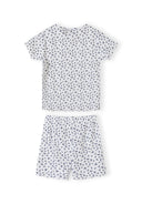 Close-up detail of white ribbed fabric with navy floral print pattern showing Minoti brand label