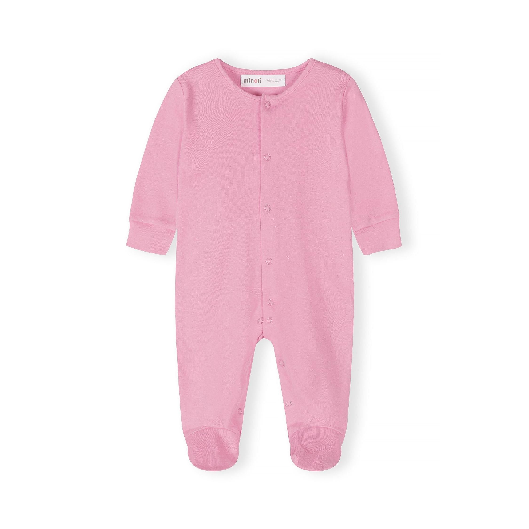 Close-up detail of cream sleepsuit showing Minoti label, snap button closures and ribbed neckline construction