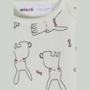 Close-up detail of white bodysuit showing Minoti label and cute rabbit illustrations with pink bow ties