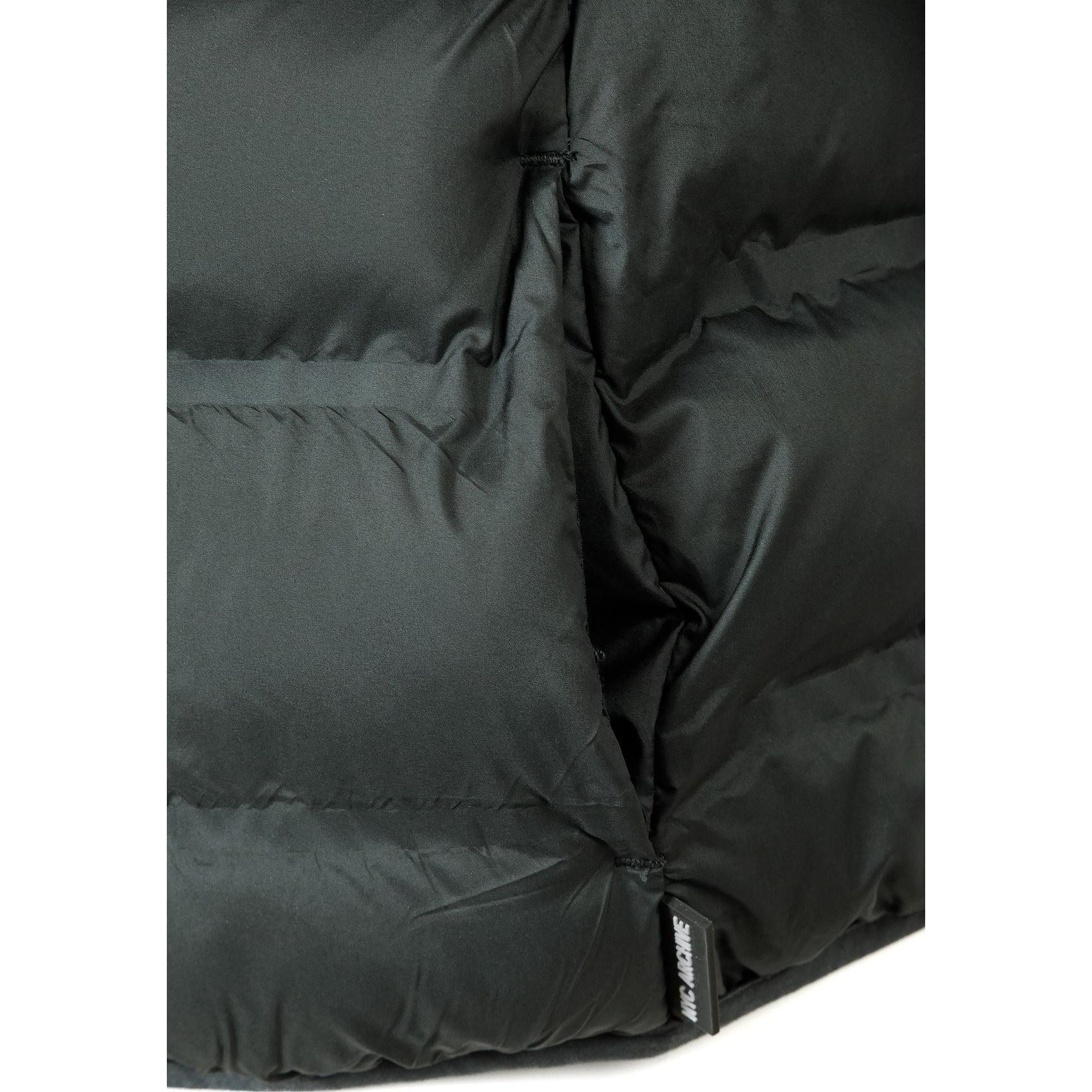 Close-up detail of emerald green padded jacket showing quilted texture and fabric construction