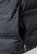 Detail of a boys' lightweight black jacket with dual side pockets.