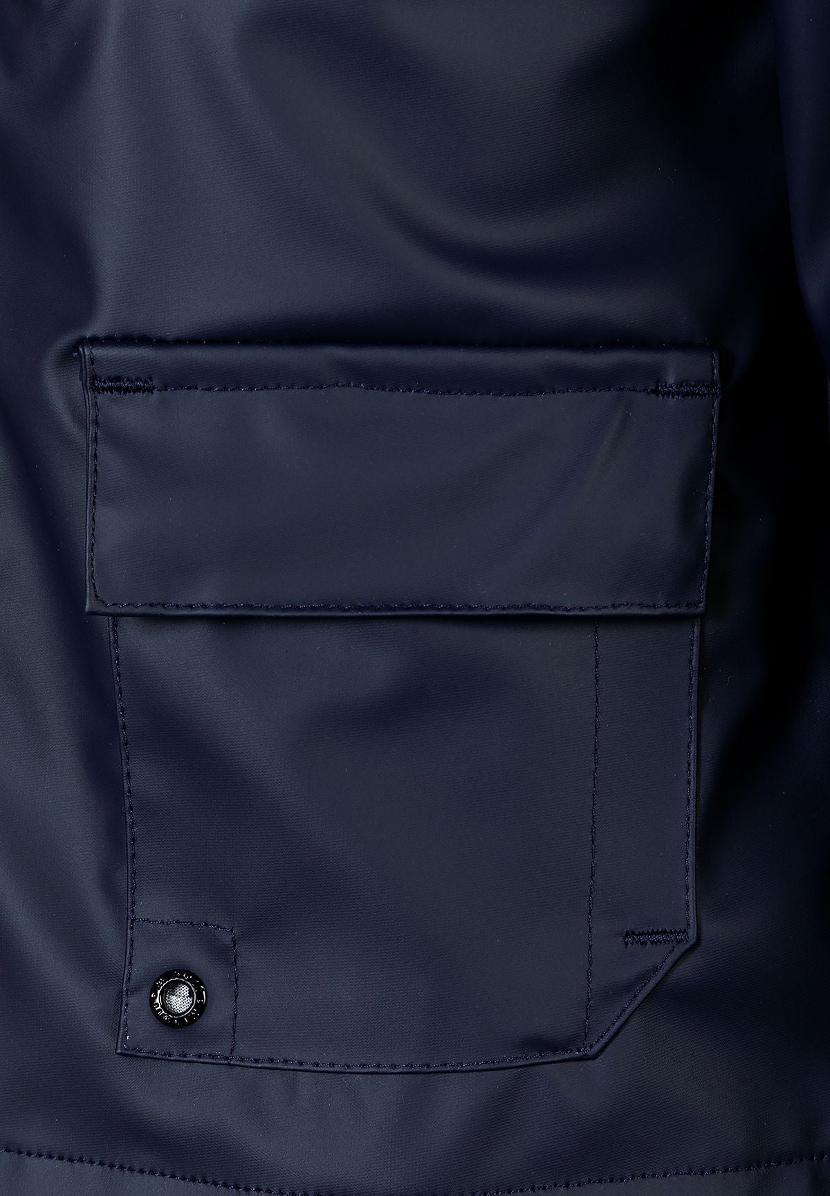 Close-up of the flap pocket on the navy hooded jacket.