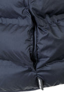 Detail of navy blue lightweight gilet with padding and side pocket.