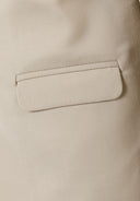 Detail of a boys formal blazer in stone color with a pocket.