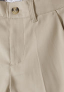 Detail of boys formal trousers in stone color with adjustable waistband and side pocket.