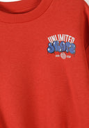 Close-up of red boys sweatshirt with urban style blue graphic print and ribbed neckline showing unique design details.