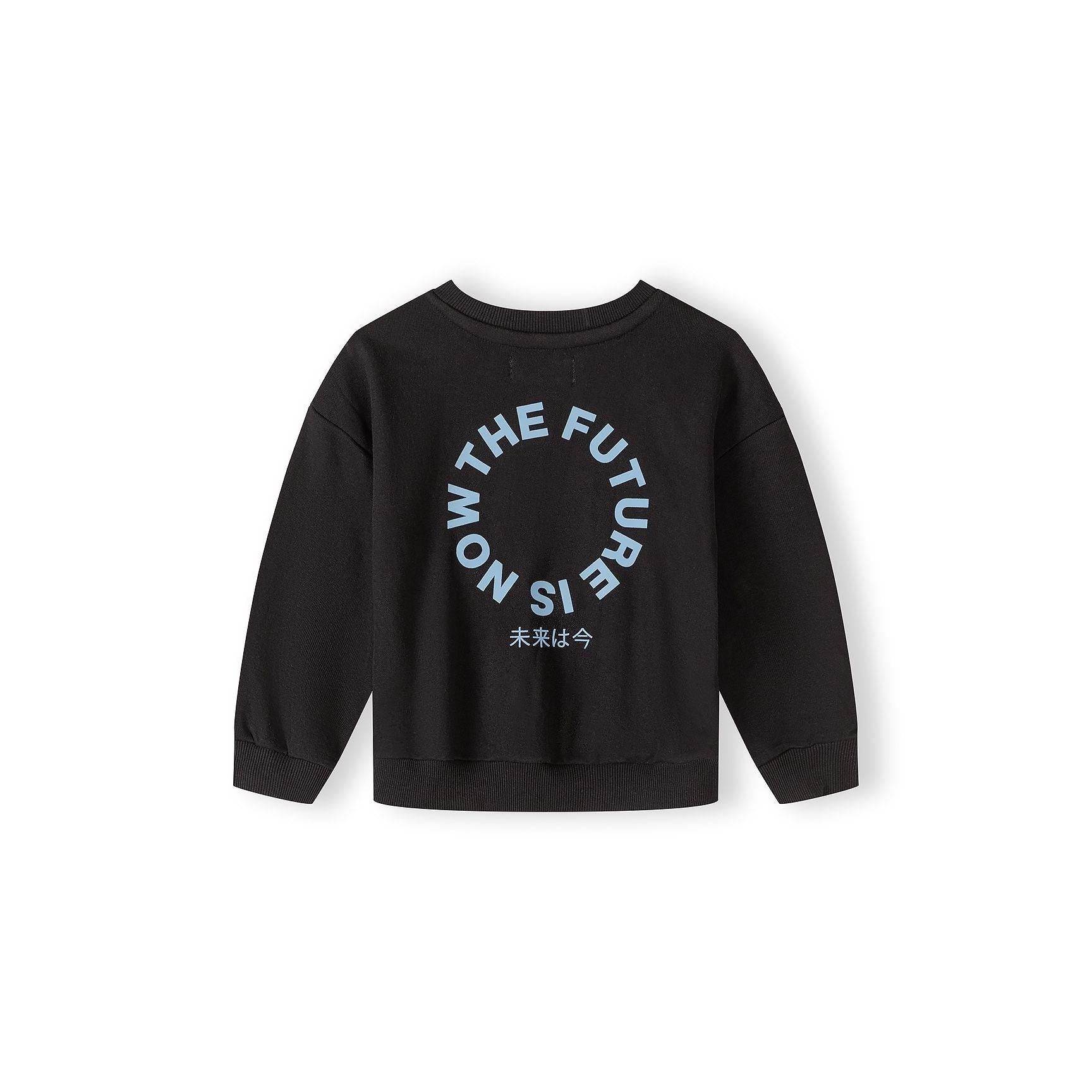 Black joggers with elastic waistband and drawstring, featuring circular printed text design on leg, displayed flat on white background