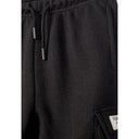 Detail shot of black cargo shorts waistband area showing drawstring ties and fabric texture with small label visible