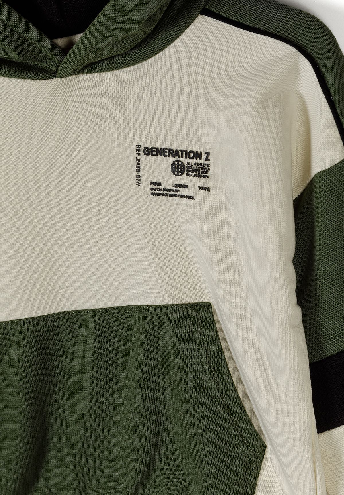 Detail of a boys khaki hooded jacket with logo and contrasting panels.