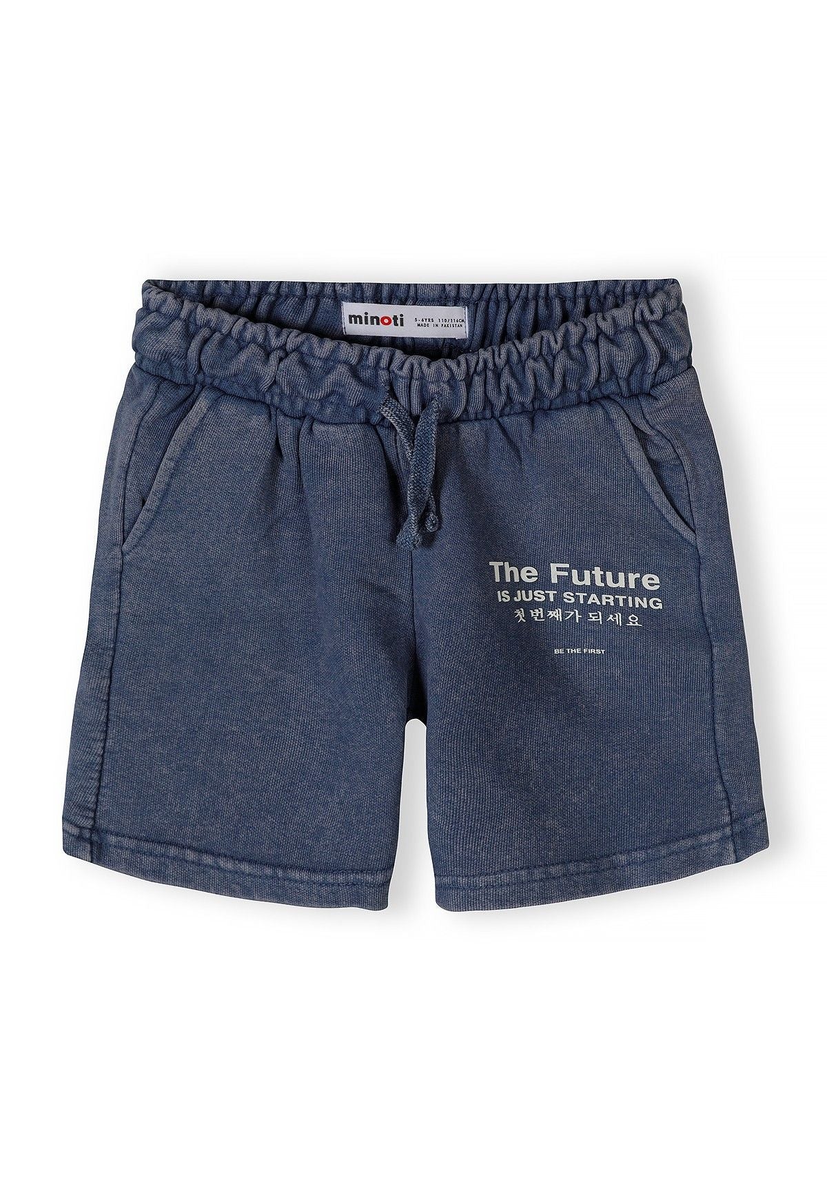 Detail of boys' blue acid wash shorts with elastic waistband and side pockets.