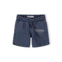Close-up detail of blue acid wash shorts waistband showing Minoti label and 'The Future is Just Starting' text with Korean translation