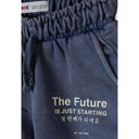 Close-up detail of blue acid wash shorts waistband showing Minoti label and 'The Future is Just Starting' text with Korean translation