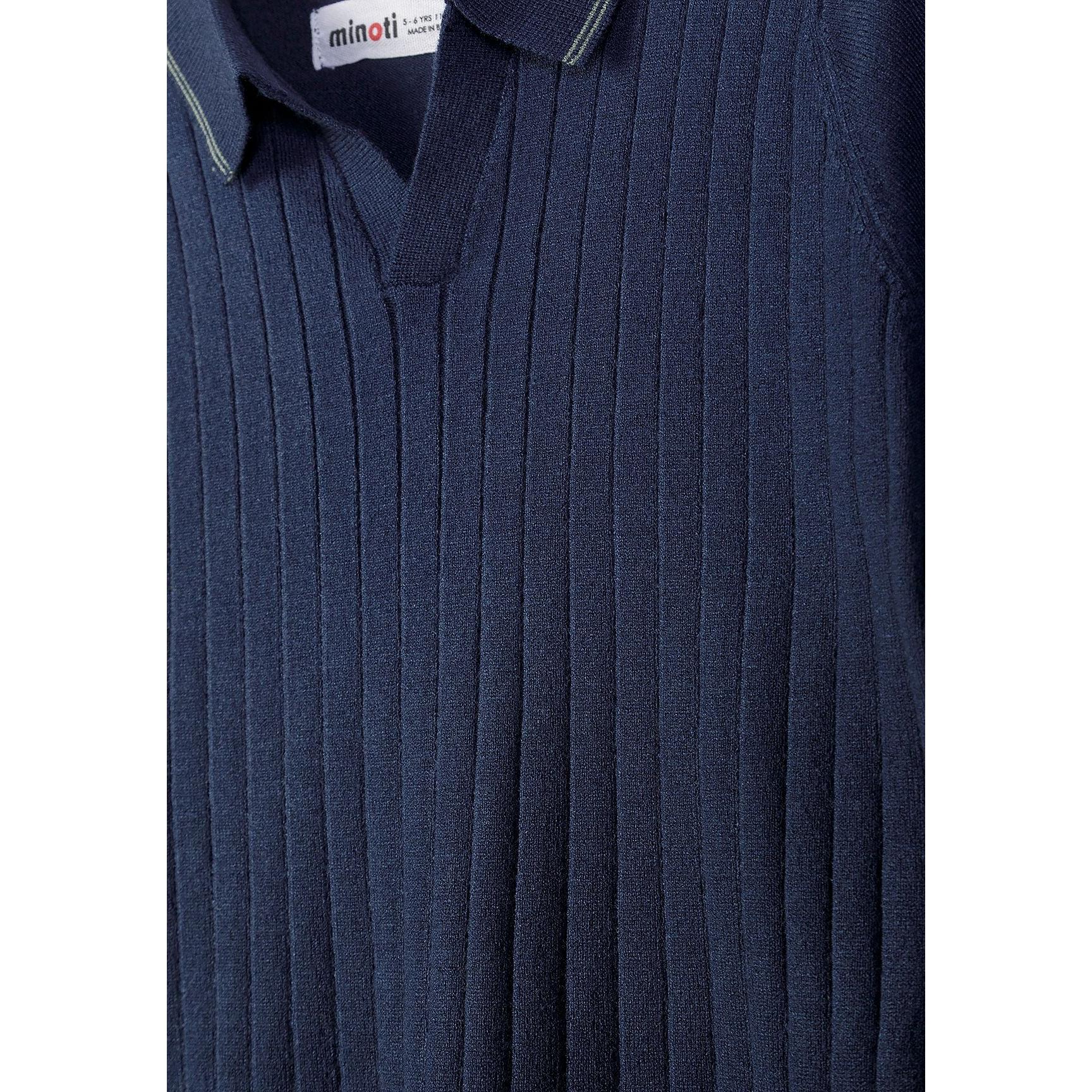 Close-up detail of navy knitted polo shirt showing Minoti label, collar construction and vertical stripe pattern