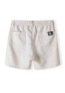 Beige linen cotton shorts with elasticated waistband and back pockets, back view.