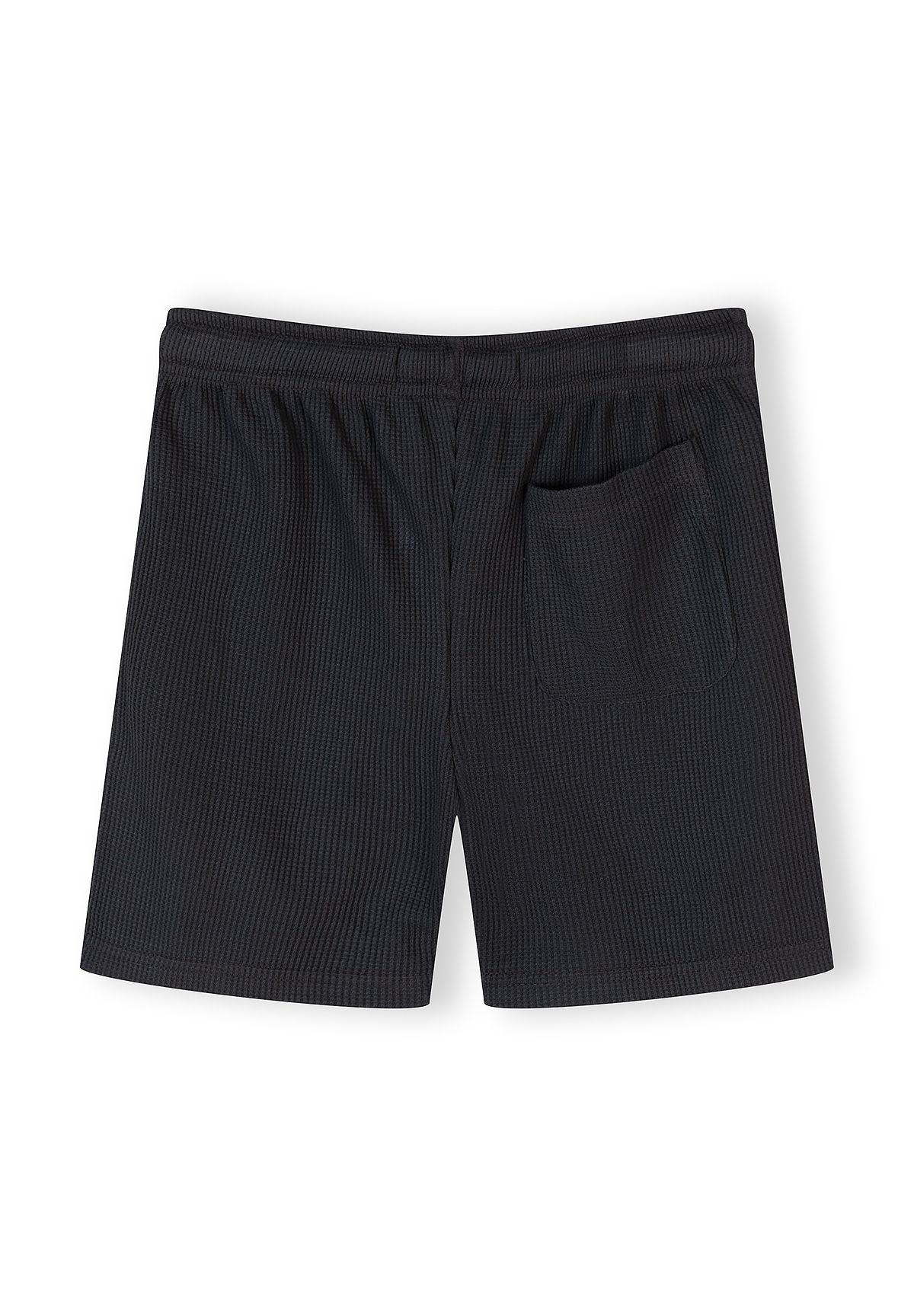 Back view of waffle-textured shorts with elasticated waistband and side pocket.