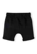 Black cotton jersey shorts for boys with elastic waistband and rolled hems showcasing simple design.