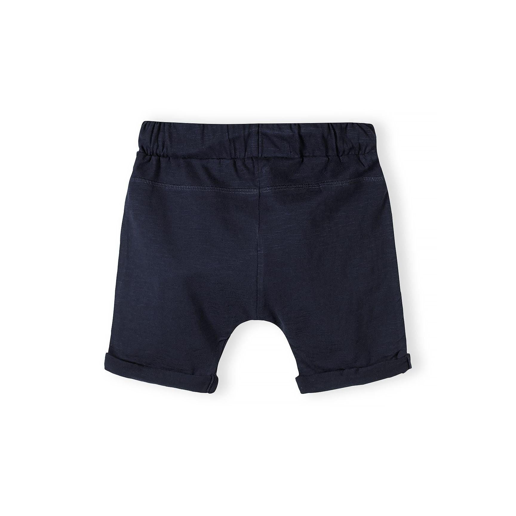 Close-up detail of light blue cotton jersey shorts showing drawstring waist with cord ties and fabric texture