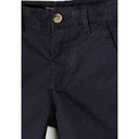 Close-up detail of navy chino shorts showing waistband construction, brown button closure, belt loop and side pocket opening