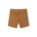 Detail view of sand chino shorts waistband area showing Minoti label, button closure, belt loops, and front pocket construction with visible topstitching