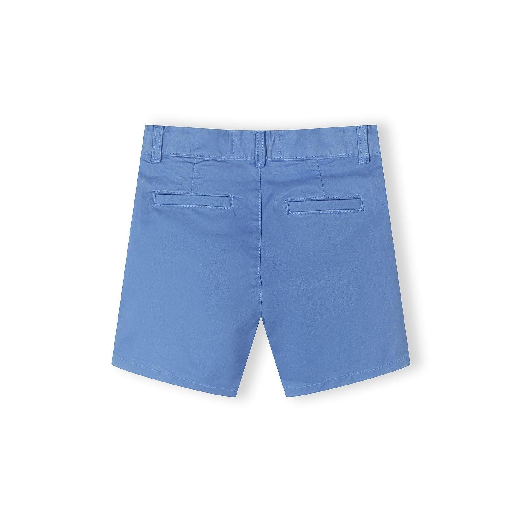Close-up detail of navy chino shorts waistband showing button closure with natural wood-tone button and belt loops