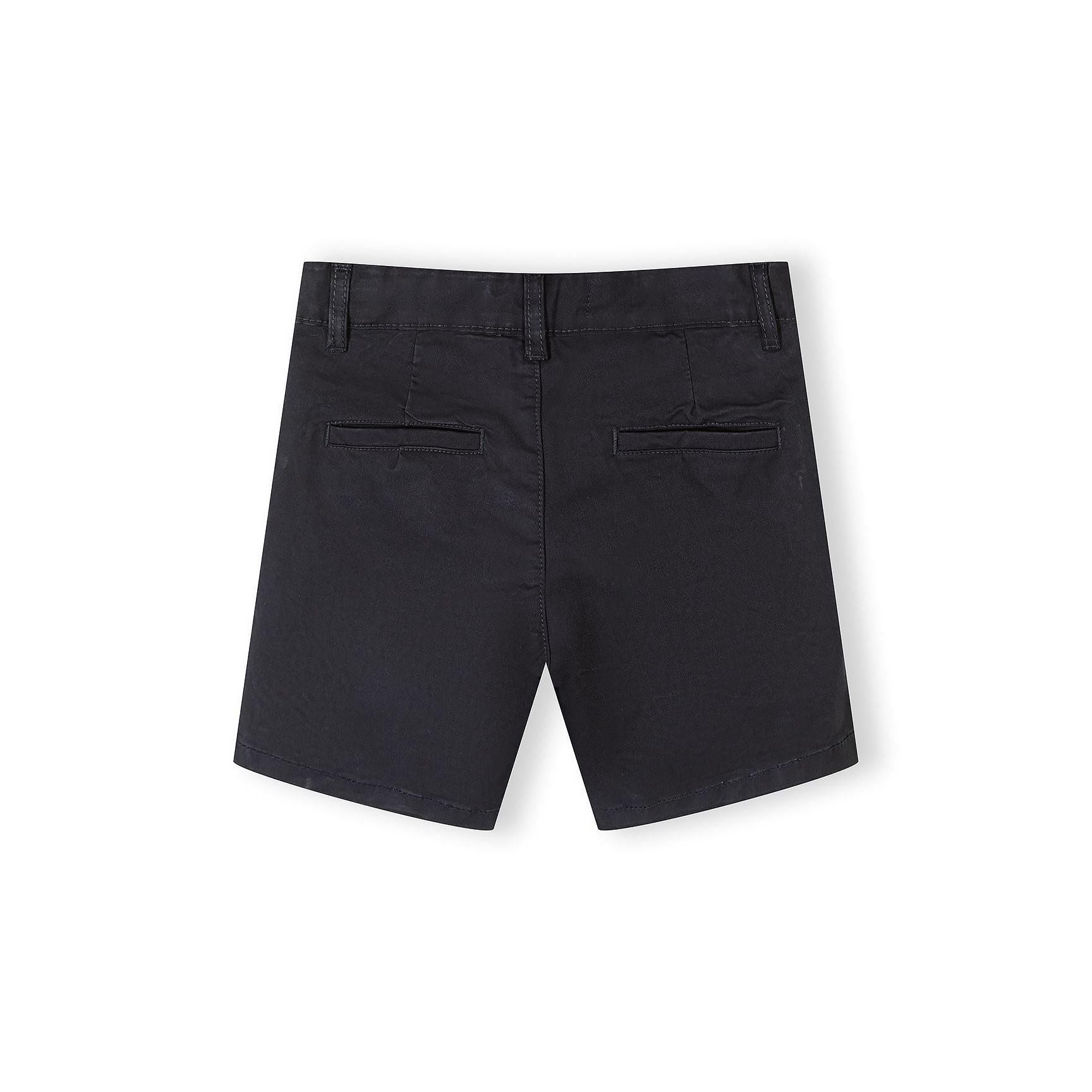 Close-up detail of navy chino shorts waistband showing button closure with natural wood-tone button and belt loops