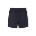 Close-up detail of sand beige shorts showing Minoti label, white drawstring with black stripe detail and front pocket stitching