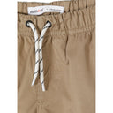 Close-up detail of sand beige shorts showing Minoti label, white drawstring with black stripe detail and front pocket stitching