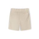 Close-up detail of beige shorts waistband showing Minoti label, elastic gathering, rope drawstring with aglets and front pocket on white background