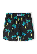 Boys swimming shorts, black with teal palm print, front view, elasticated waistband.