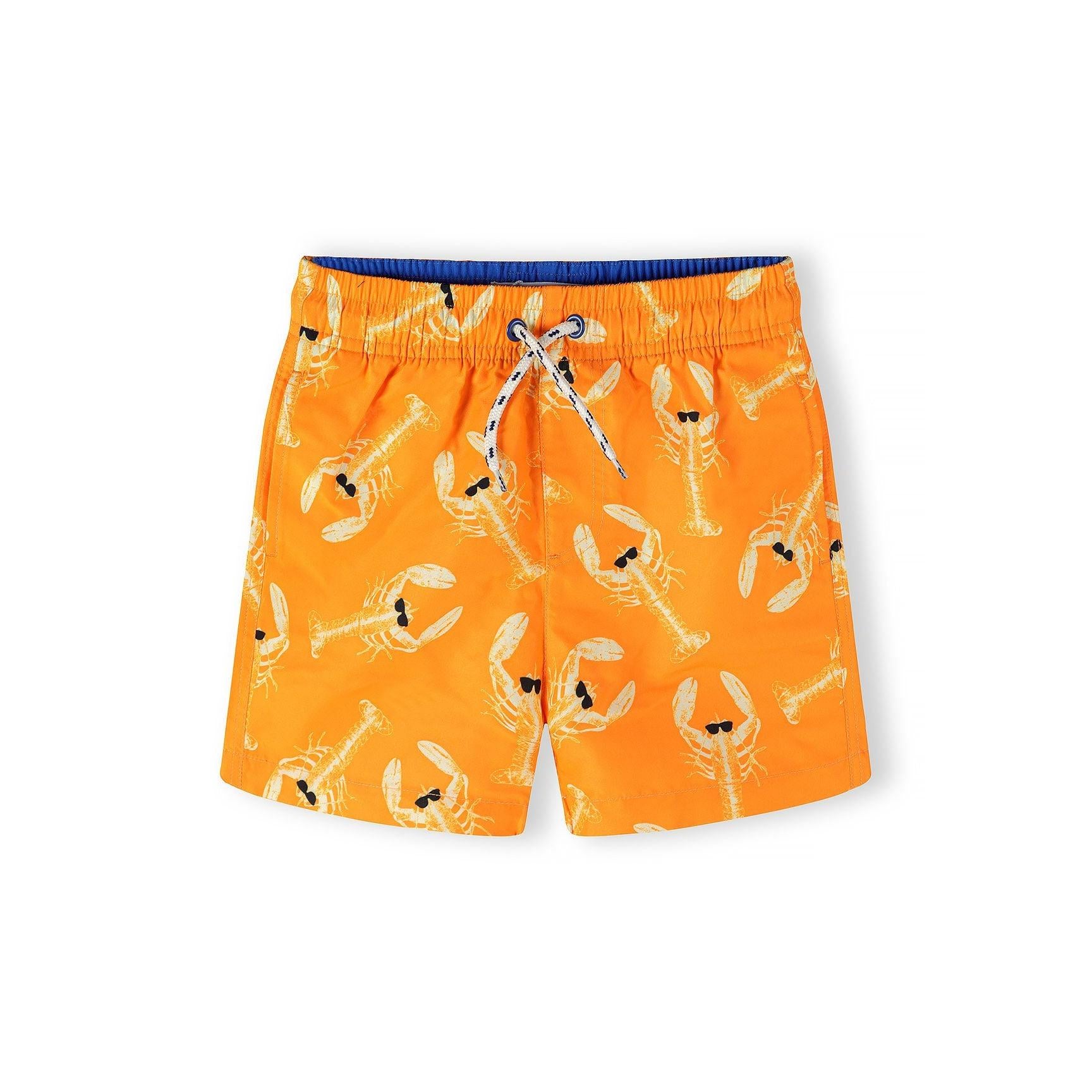 Close-up detail of orange and blue checkerboard pattern swim shorts showing elastic waistband with white drawstring cord