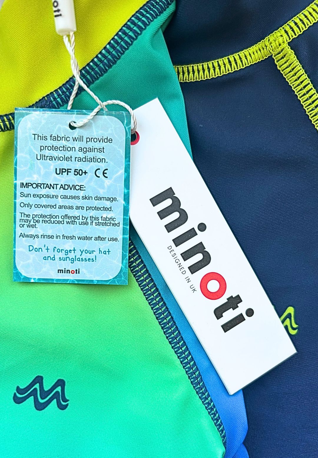 Navy, blue, green and yellow rash vests, uPF supplier hangtag.