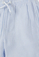 Detail of boys swim shorts with blue and white stripes, elasticated waistband.