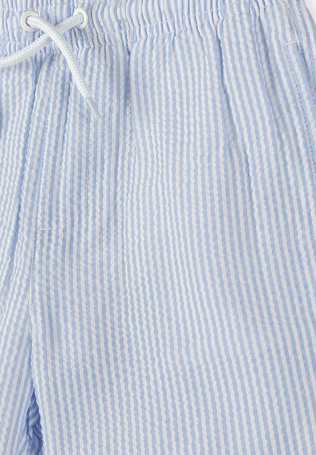 Blue/white and green/white swim shorts, blue striped texture and waist.