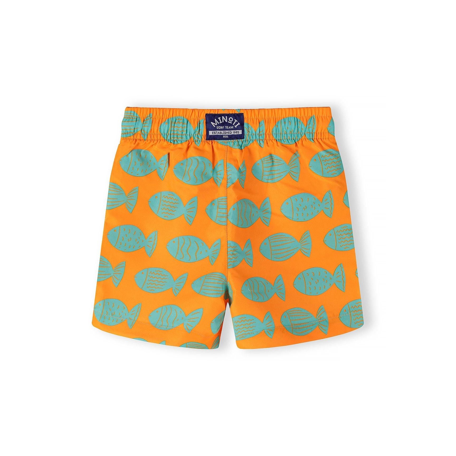 Close-up detail of orange swim shorts showing turquoise fish print pattern with various fish shapes and sizes, white drawstring visible at waistband