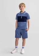 Boys' short-sleeved polo shirt with zip collar and matching shorts, front view.