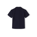 Boys navy blue polo shirt, back view, short sleeves, structured collar.