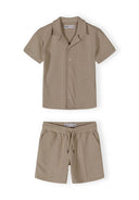 Boys cotton polo shirt and shorts set in muted sand, front view with button placket and elasticated waistband.