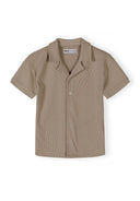 Boys polo shirt in muted sand, front view, featuring a classic collar and button placket.
