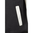 Close-up detail of black jacket showing white ribbed side pocket trim and construction