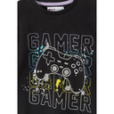 Detail shot of grey shorts with colorful splatter pattern featuring blue, yellow, purple and black paint splashes on light grey fabric